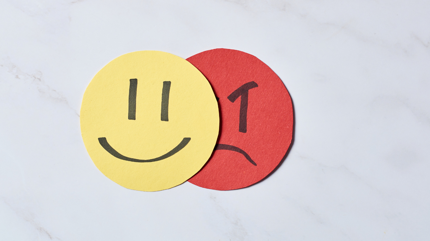 A composite image of Sean Awakuni displaying contrasting emotions—one side showing happiness with a bright smile and the other side depicting sadness with a somber expression—symbolizing the dual aspects of psychiatry and mental health.